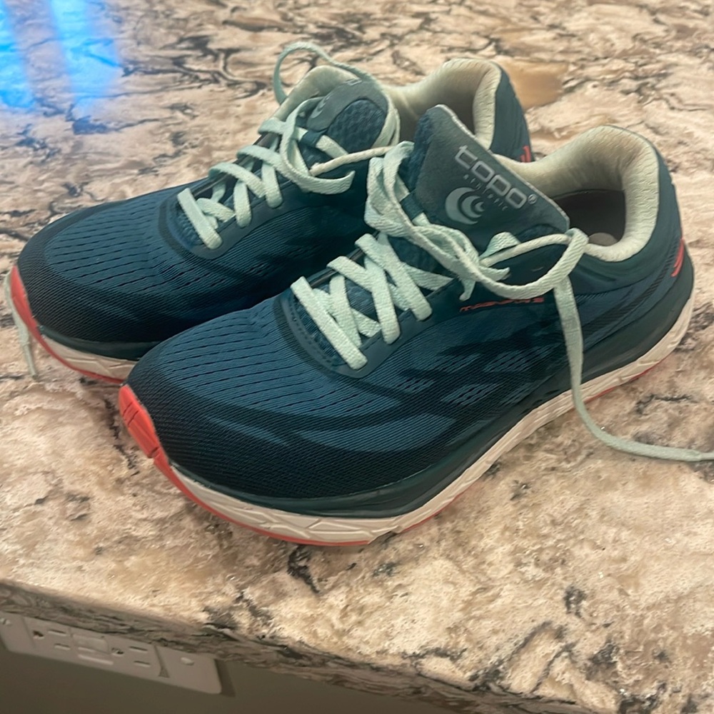 Greenish blue! I would say a darker teal color topo woman’s size 8 running shoe